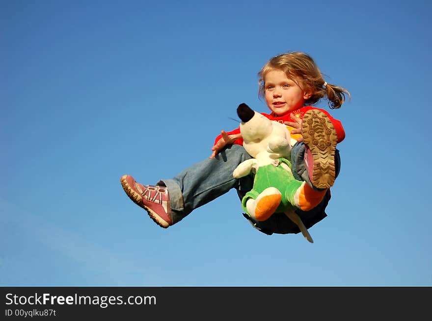 Flying pretty girl, holding toy in hands. Flying pretty girl, holding toy in hands