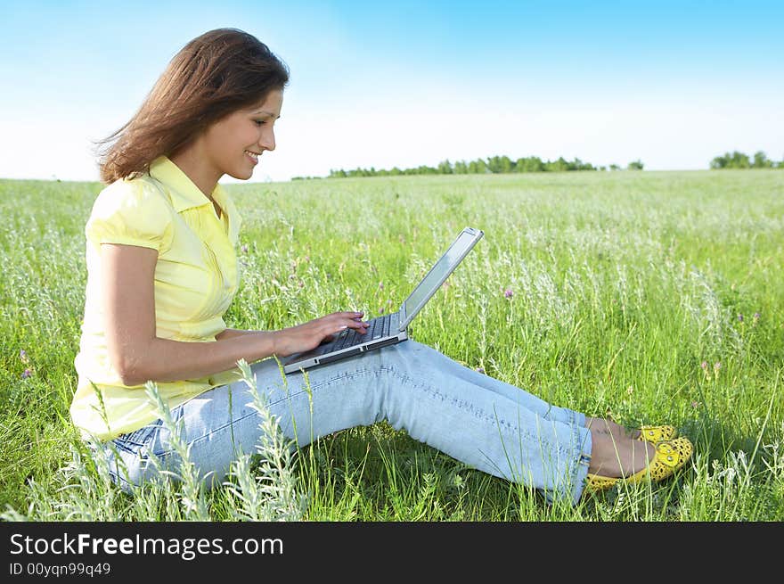 Pretty Woman With Laptop On The Green Grass