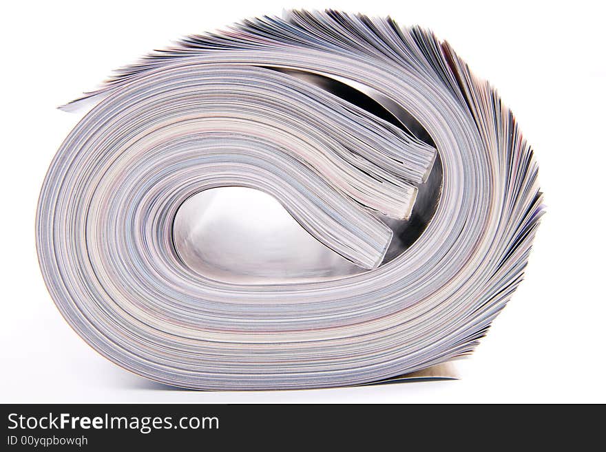 Three rolled magazines on white background