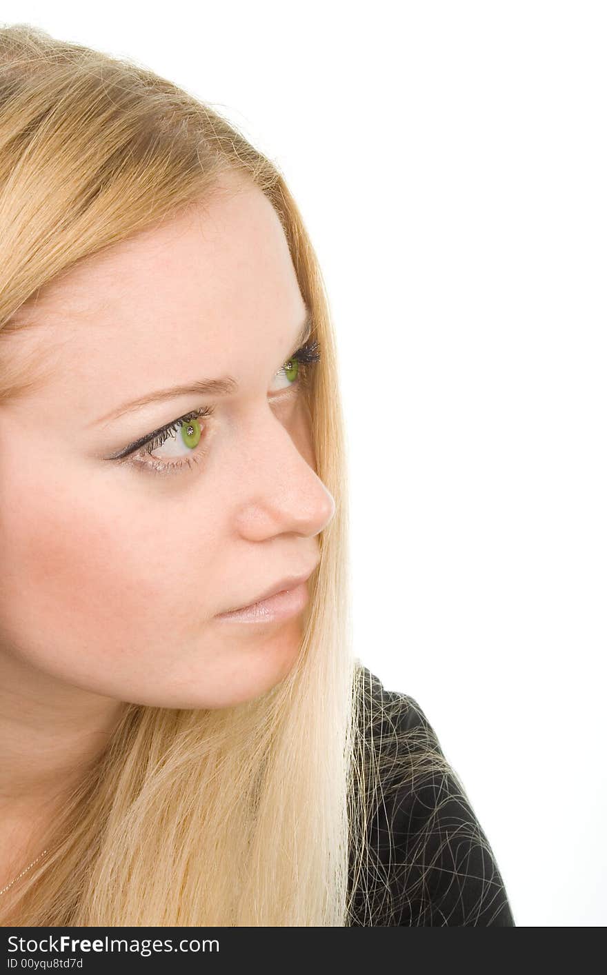 Portrait of young attractive green-eyed dreaming woman in black on white background