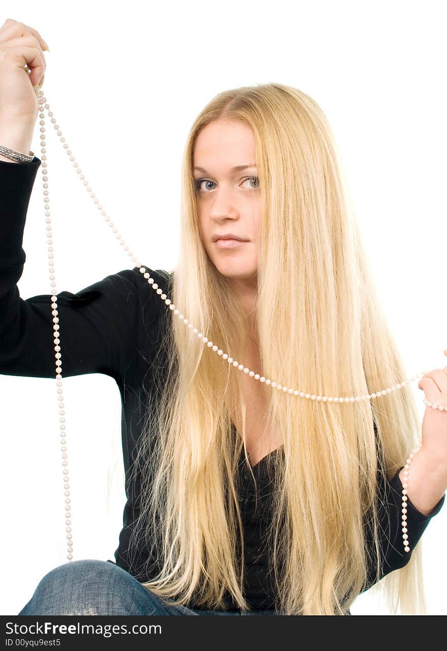 Portrait of the beautiful blond woman with a pearl necklace in her hands. Portrait of the beautiful blond woman with a pearl necklace in her hands