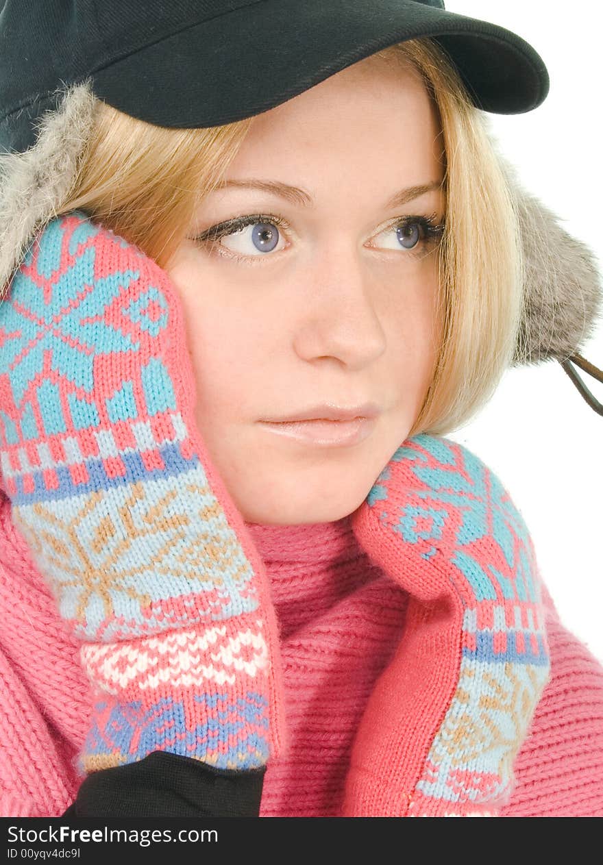 Pretty blue-eyed blonde in fur cap, pink scarf and mitten