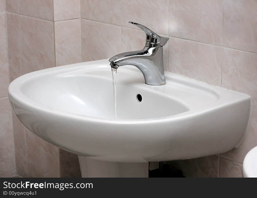 Open modern water faucet and basin