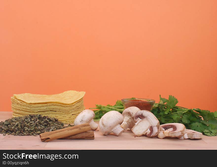 Mushrooms, Cilantro, and Tortillas on Orange Background. Mushrooms, Cilantro, and Tortillas on Orange Background