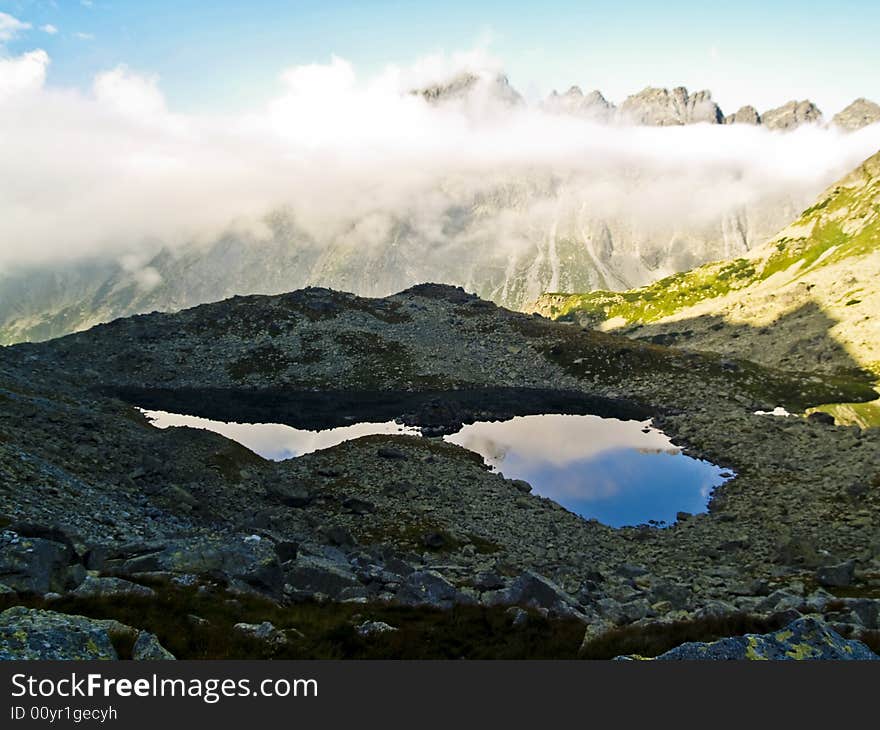 Clouds under mountain top, small beauty pond in Tatra. Clouds under mountain top, small beauty pond in Tatra