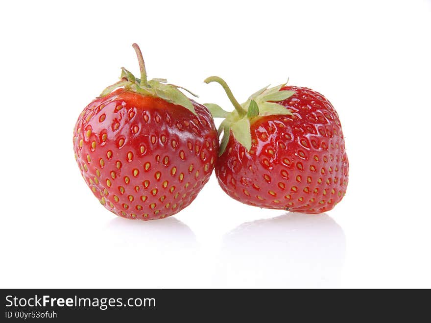 Ripe strawberry with reflection on a plate