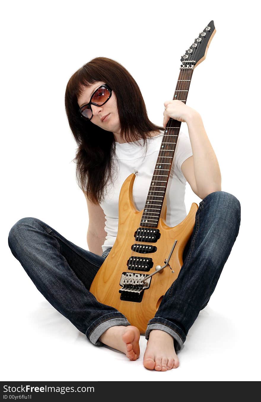 Pretty young girl sitting and holding an electric guitar. Pretty young girl sitting and holding an electric guitar