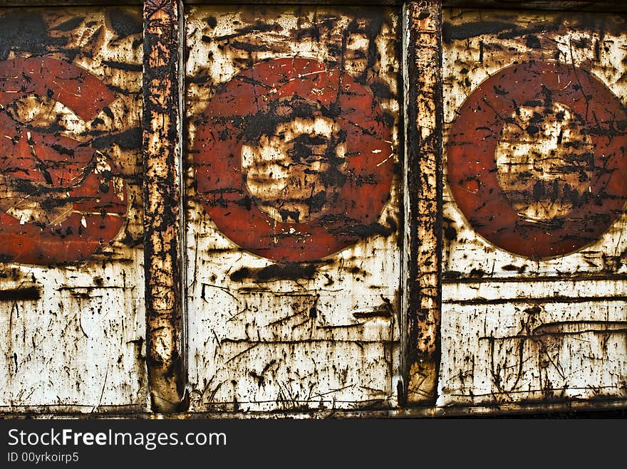 Side of rusted rail car red letters