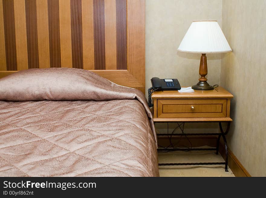 Bed and bedside table in the hotel. Bed and bedside table in the hotel