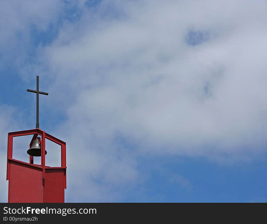 1970s church bell with scattered clouds in the background.