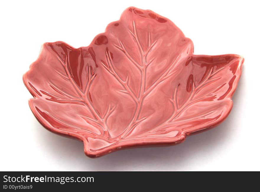 A photograph of a leaf shaped dish against a white background. A photograph of a leaf shaped dish against a white background