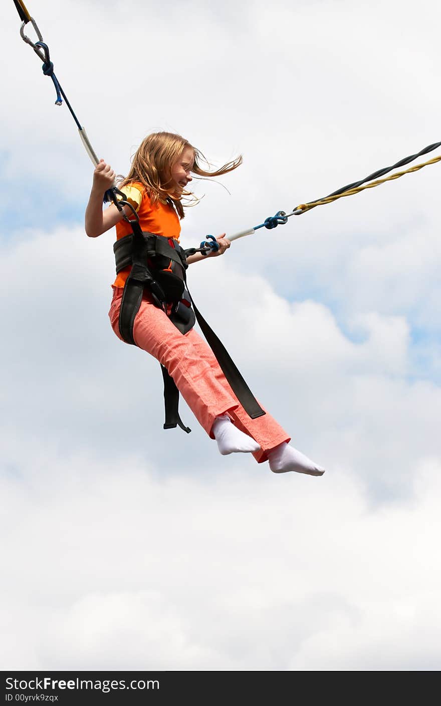 Happy girl landing with paratroop in the amusement park. Happy girl landing with paratroop in the amusement park