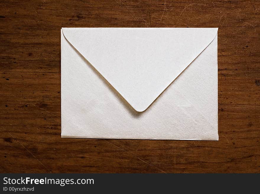 White envelope on wooden surface. White envelope on wooden surface.