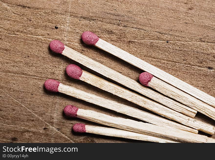 Matches on wooden surface.