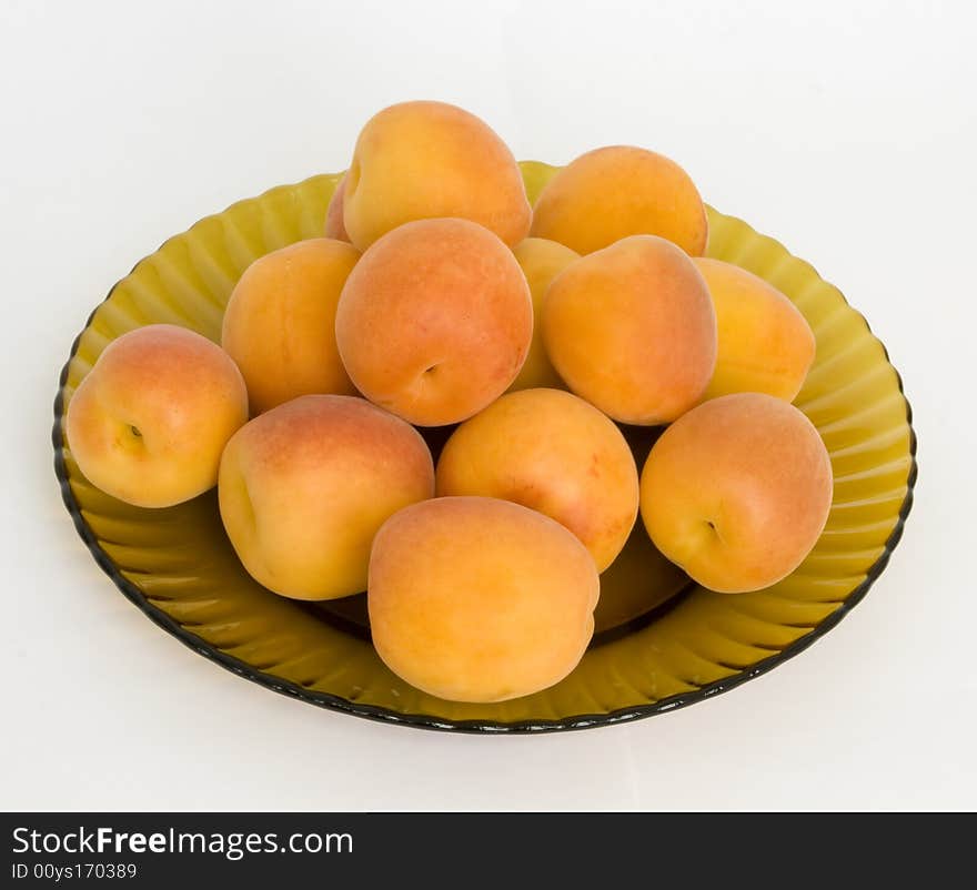 Ripe apricots on a dish from brown glass