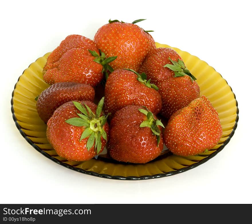 Ripe garden strawberry on a brown glass dish