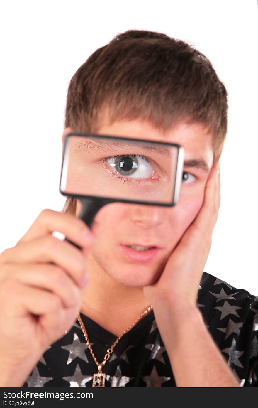 Young man looks through magnifier