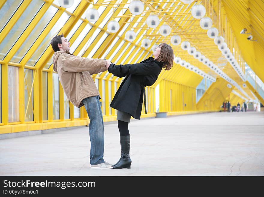 Boy and girl hold each other for  hands on  footbridge