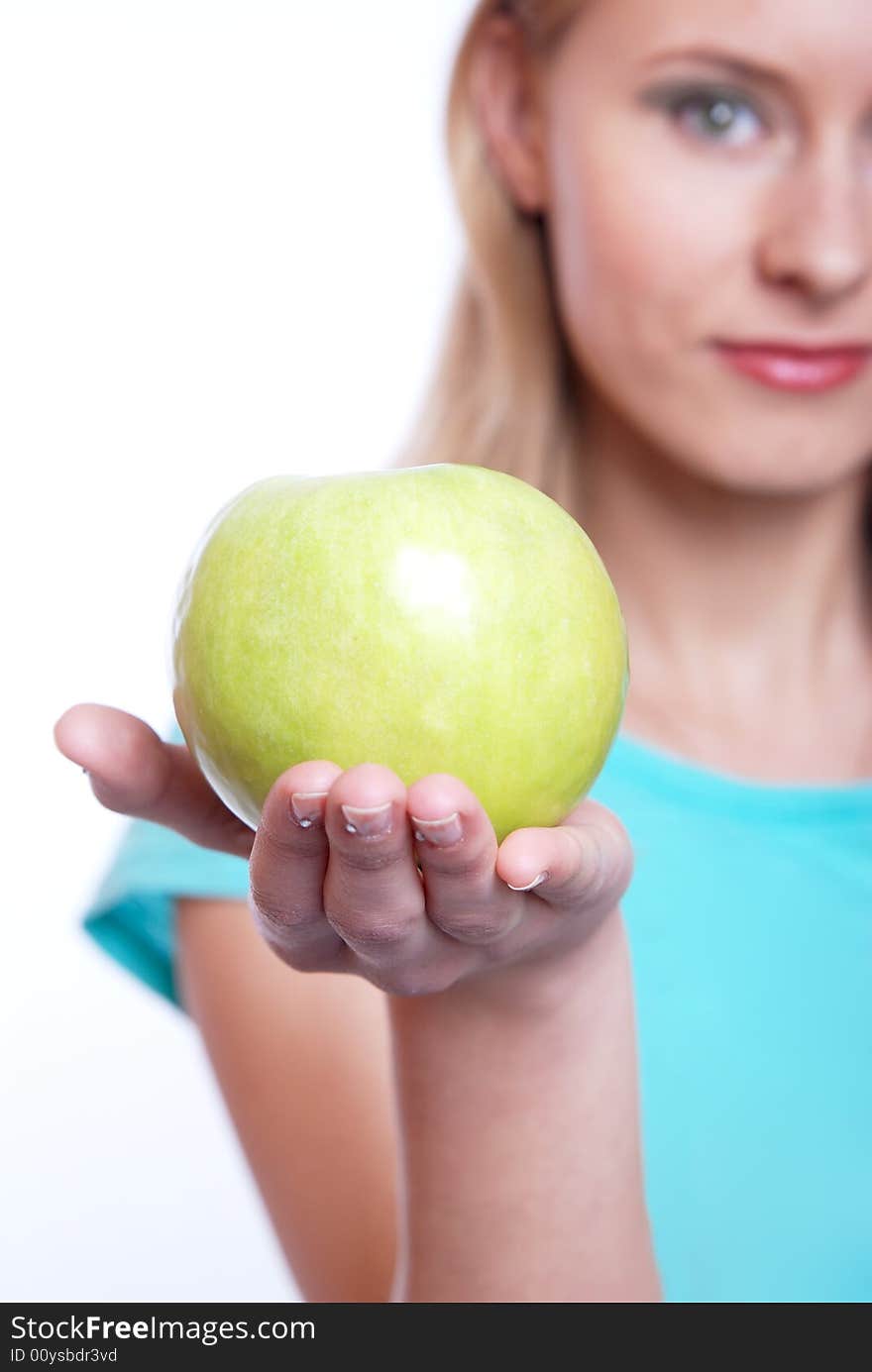 The girl with a green apple on a white background