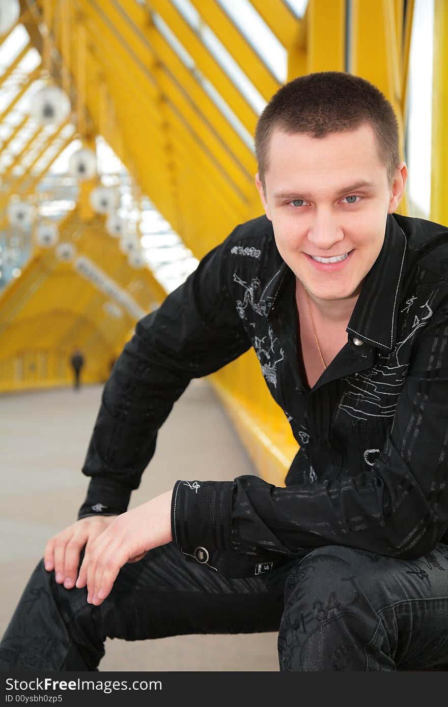 Smiling guy  on yellow footbridge. Smiling guy  on yellow footbridge