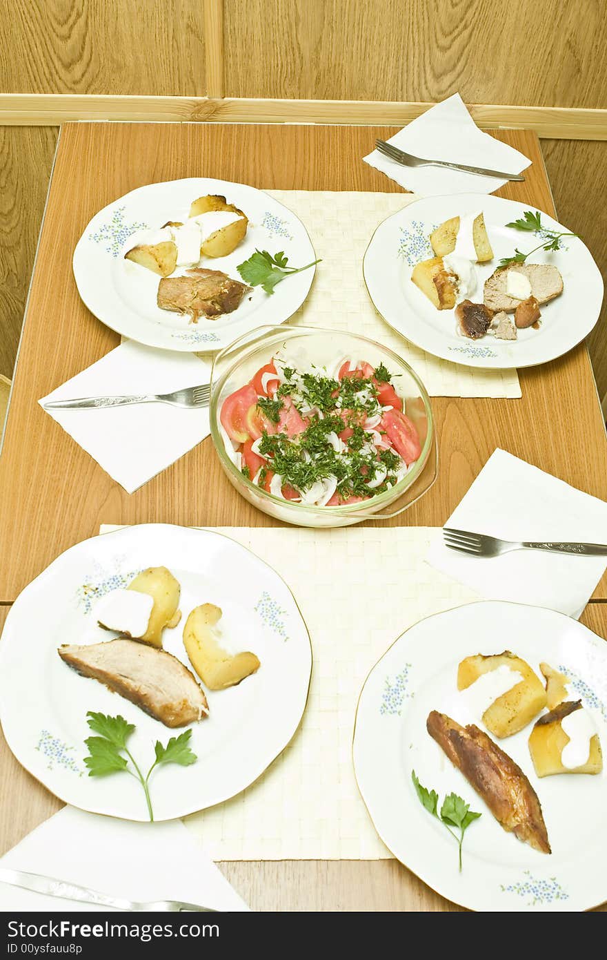 Meal for four people on table and salad