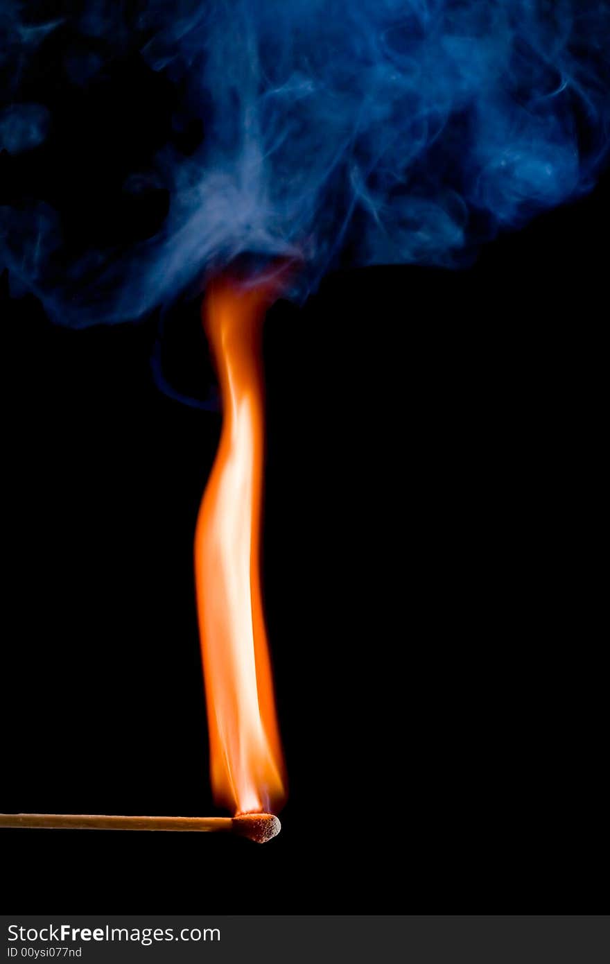 Match with a flame on dark background. Match with a flame on dark background