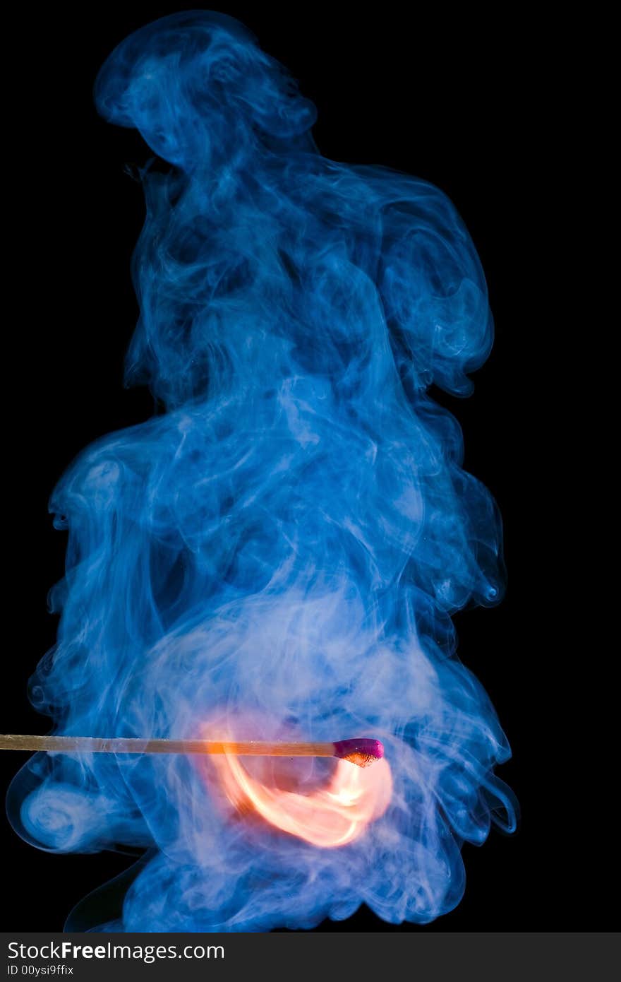 Match with a flame and smoke on dark background. Match with a flame and smoke on dark background