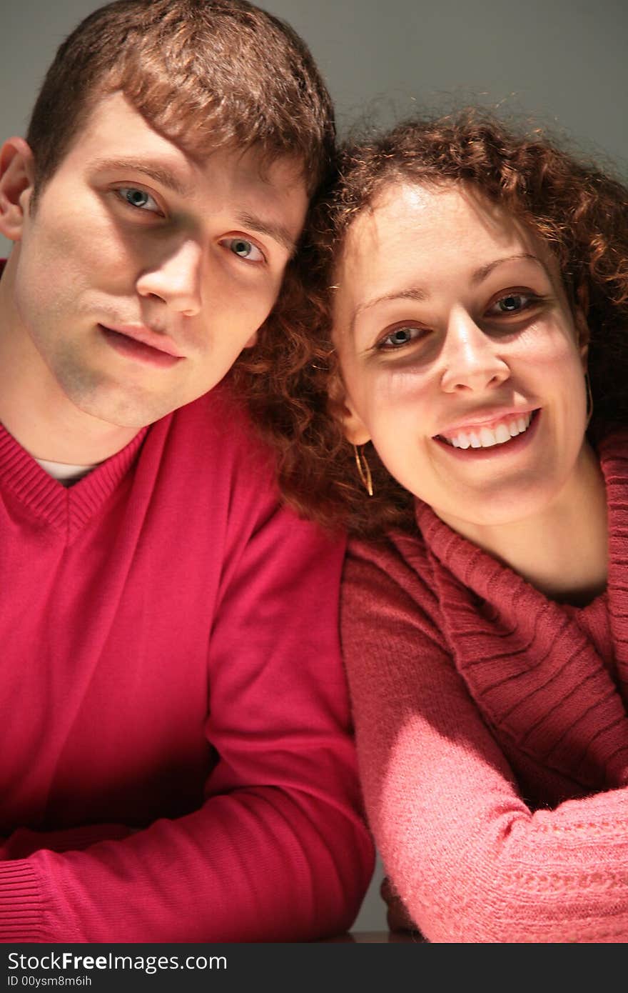 Young pair on a grey background