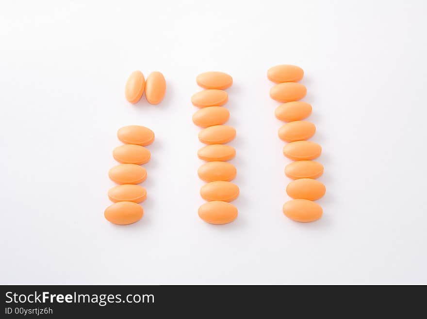 Orange color pills composing the english word ill. Orange color pills composing the english word ill