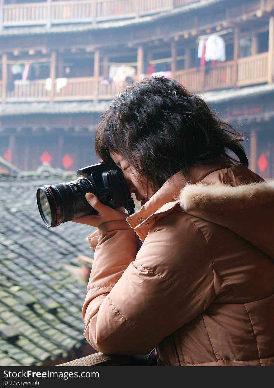 A Chinese girl is photographing. A Chinese girl is photographing.