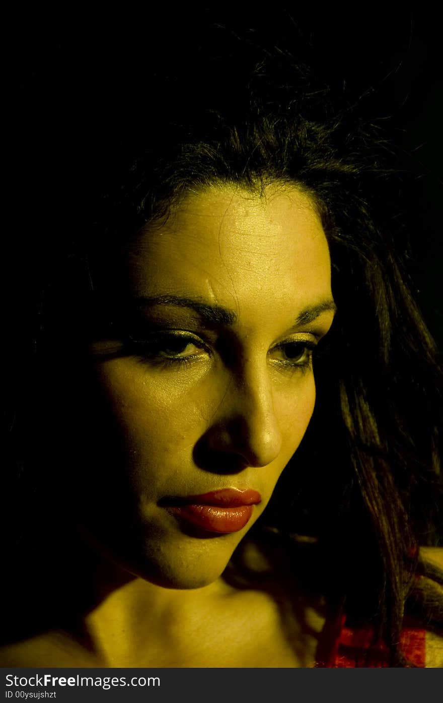 A portrait of a young lady with red lipstick and a red teddy, shot with a yellow tint. A portrait of a young lady with red lipstick and a red teddy, shot with a yellow tint