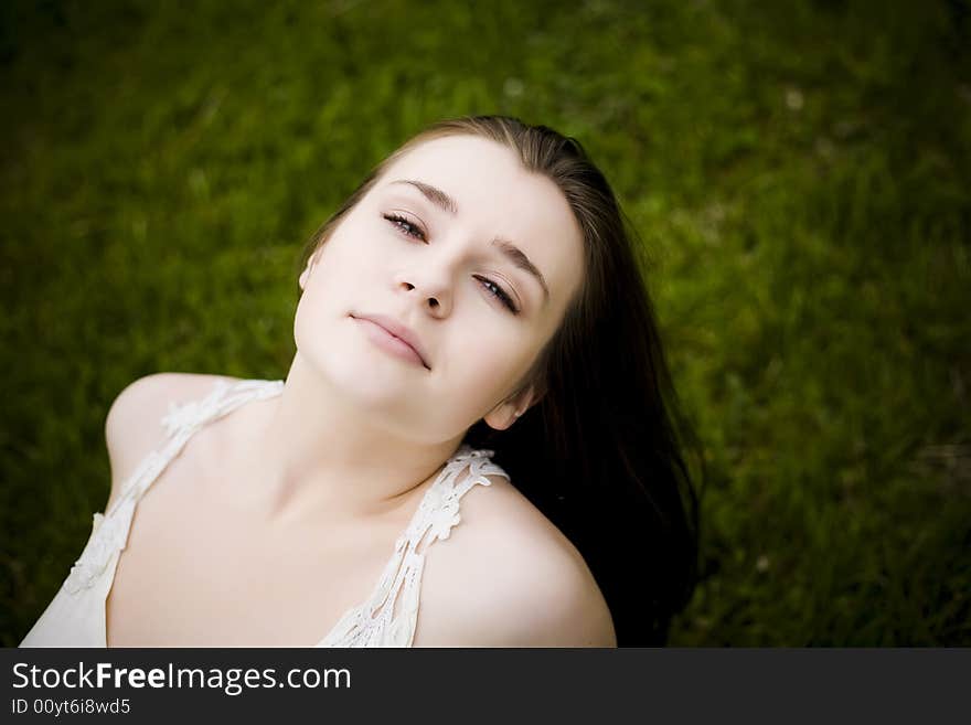 Relaxing Woman On The Grass