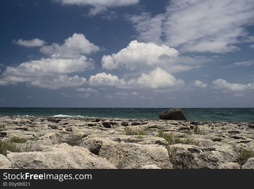 A seaside landscape with rocks, sea and a cloudy sky. A seaside landscape with rocks, sea and a cloudy sky.