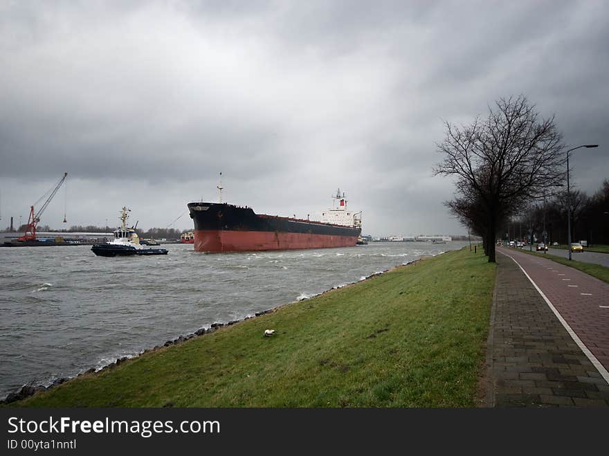 A tugboat and big ship in the canal