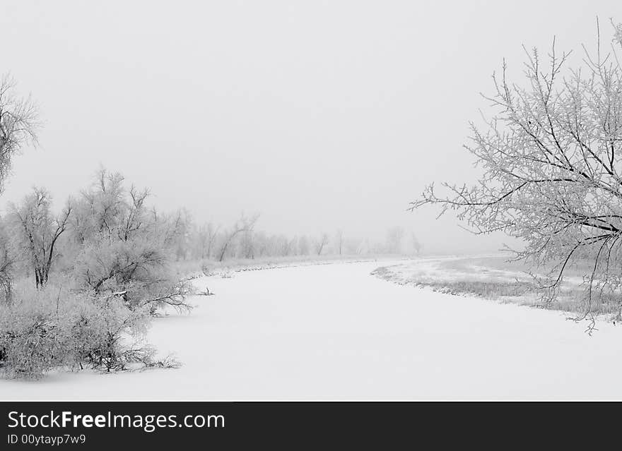 The James river in South Dakota on a frosty and foggy winter morning. The James river in South Dakota on a frosty and foggy winter morning.