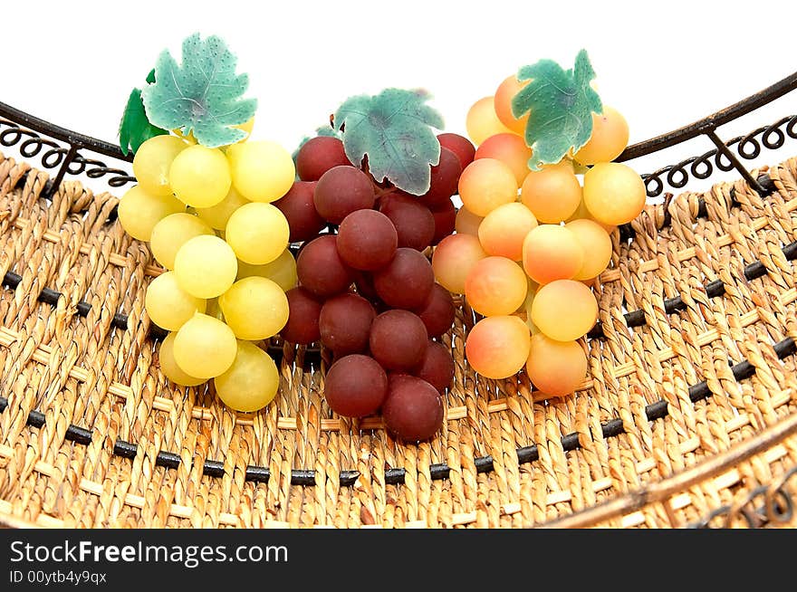 Three bunches of grapes in basket.