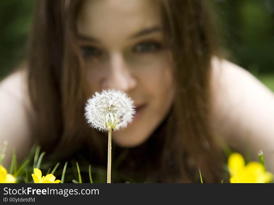 The Woman Looking At A Dandelion (Focus On Dandelion)