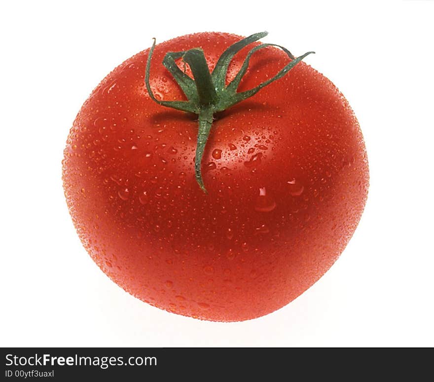 Red tomato on a white background with drops of water