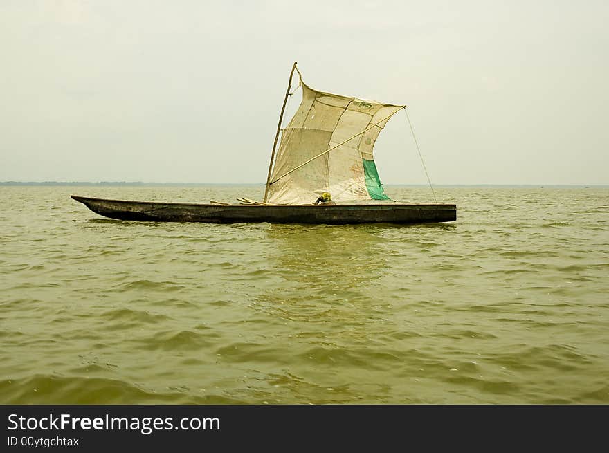 Sailing wooden fishing canoa