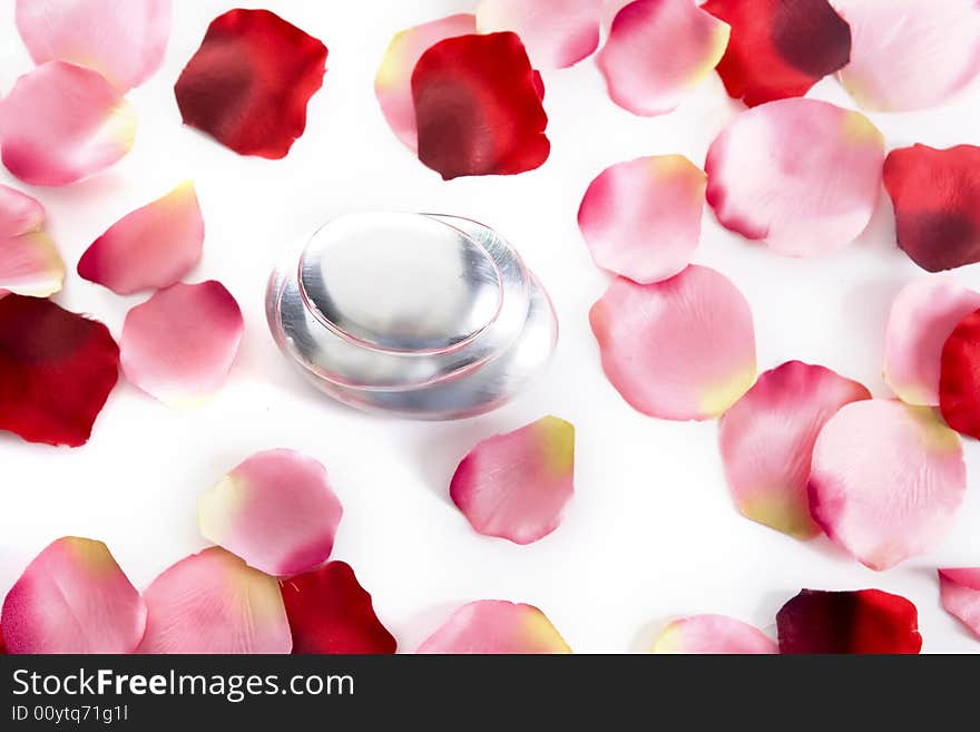 Pile of round pebbles with rose petals