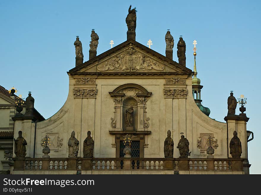 A historic facade, full of statues in the evening sun