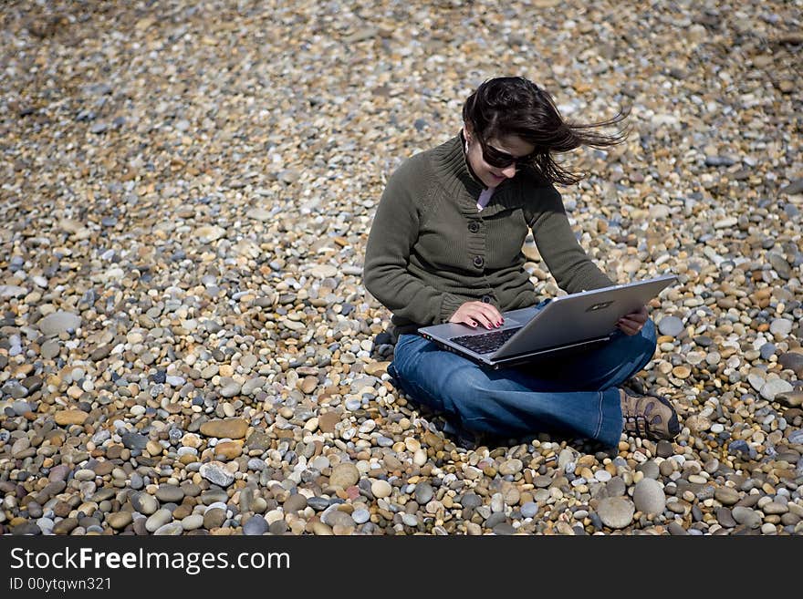 Young Woman With Laptop Computer In Beach