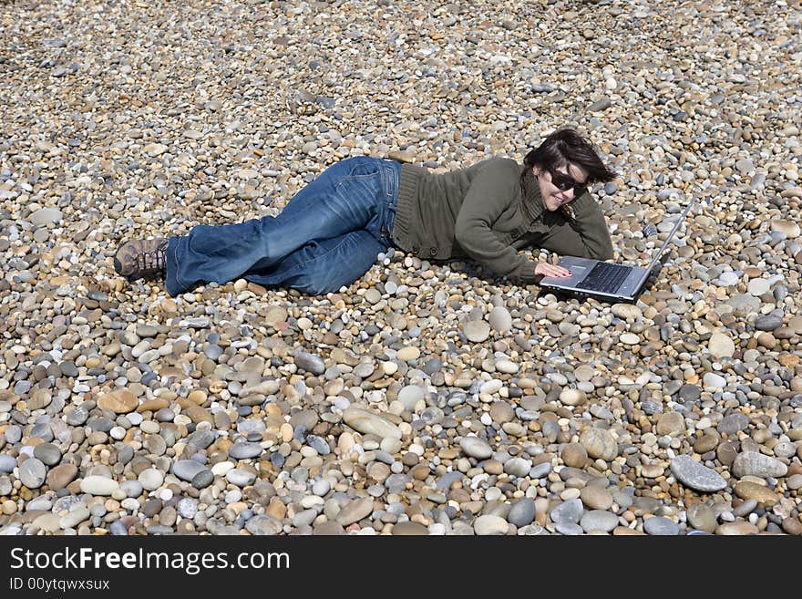 Young woman with laptop computer in beach