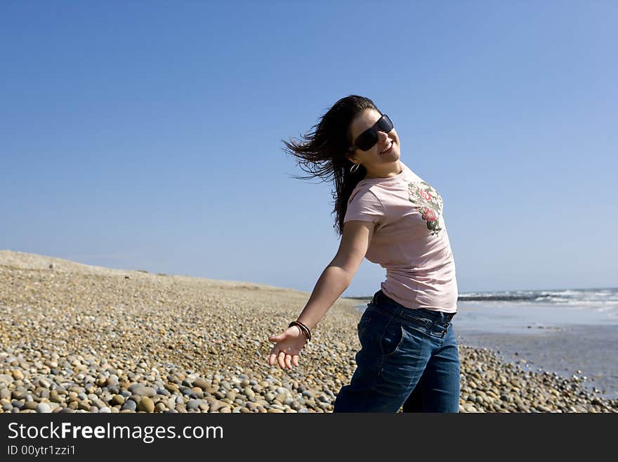 Young joyful woman in beach during hot summer day