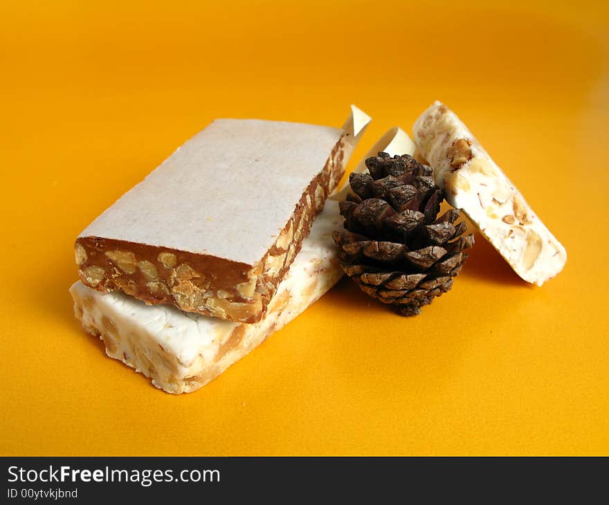 Nougat with a pine cone on a yellow background