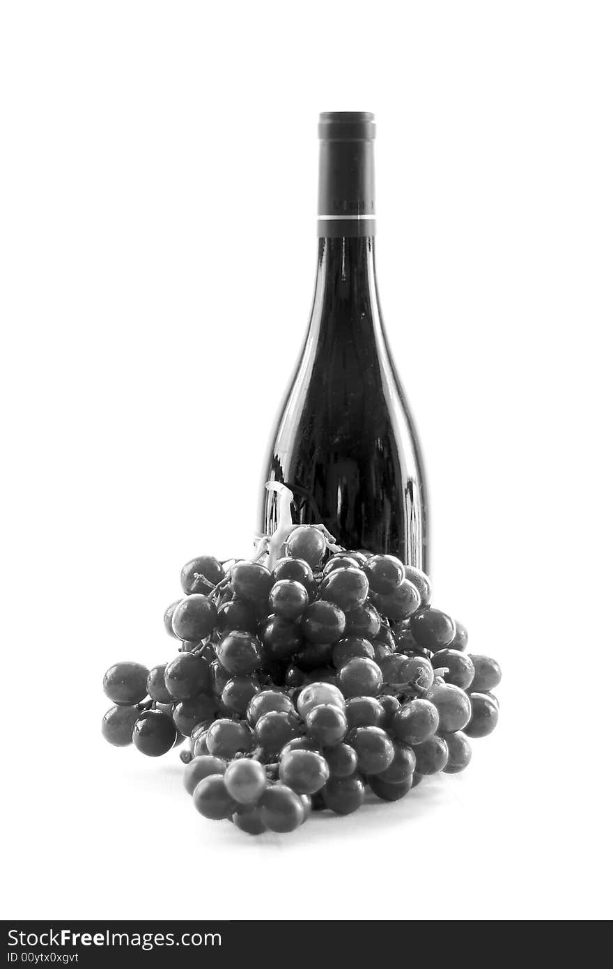 Beautiful black and white stark image of grapes turning into a wine bottle. Beautiful black and white stark image of grapes turning into a wine bottle