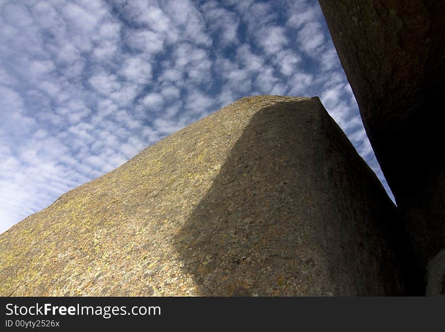 A boulder in the Wichita National Wildlife Refuge in Oklahoma framing the sky and clouds. A boulder in the Wichita National Wildlife Refuge in Oklahoma framing the sky and clouds.