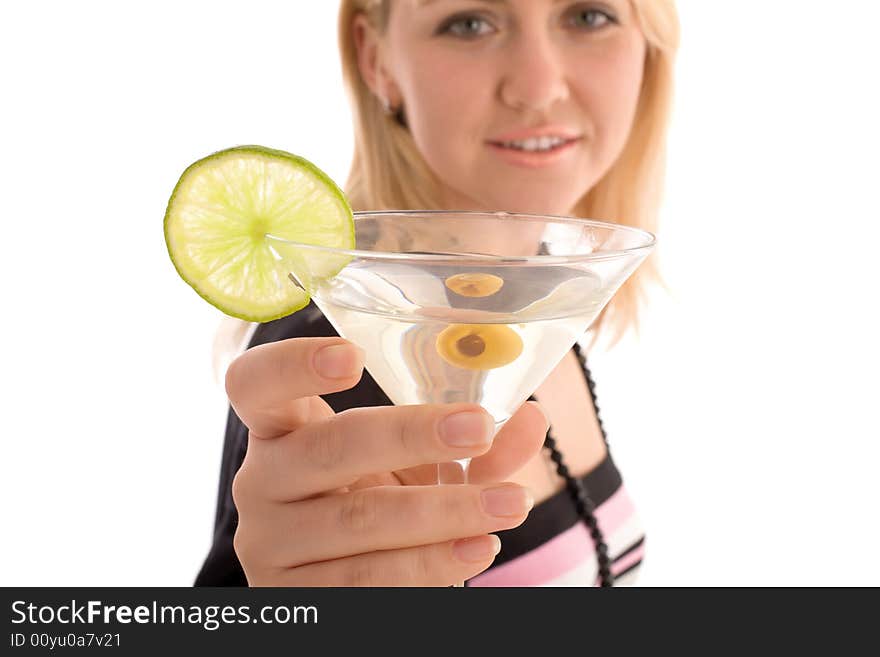 Girl reaching to you glass with martini cocktail. Focus on the glass with blured girl face