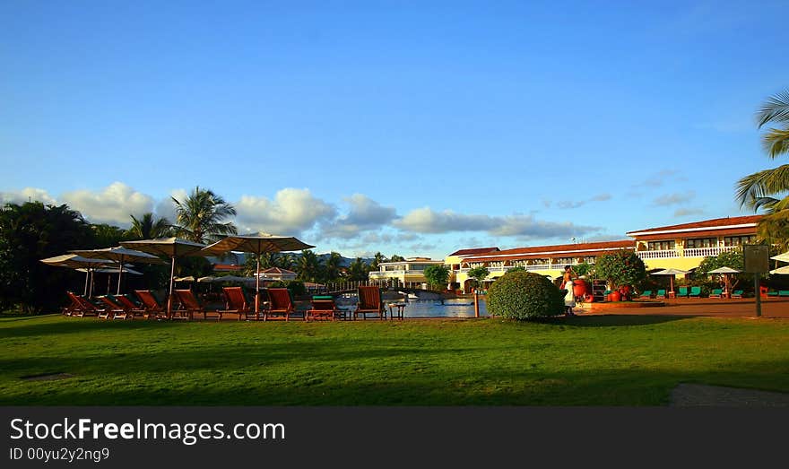 A beautiful resort in yellow with nice flowers in the garden.