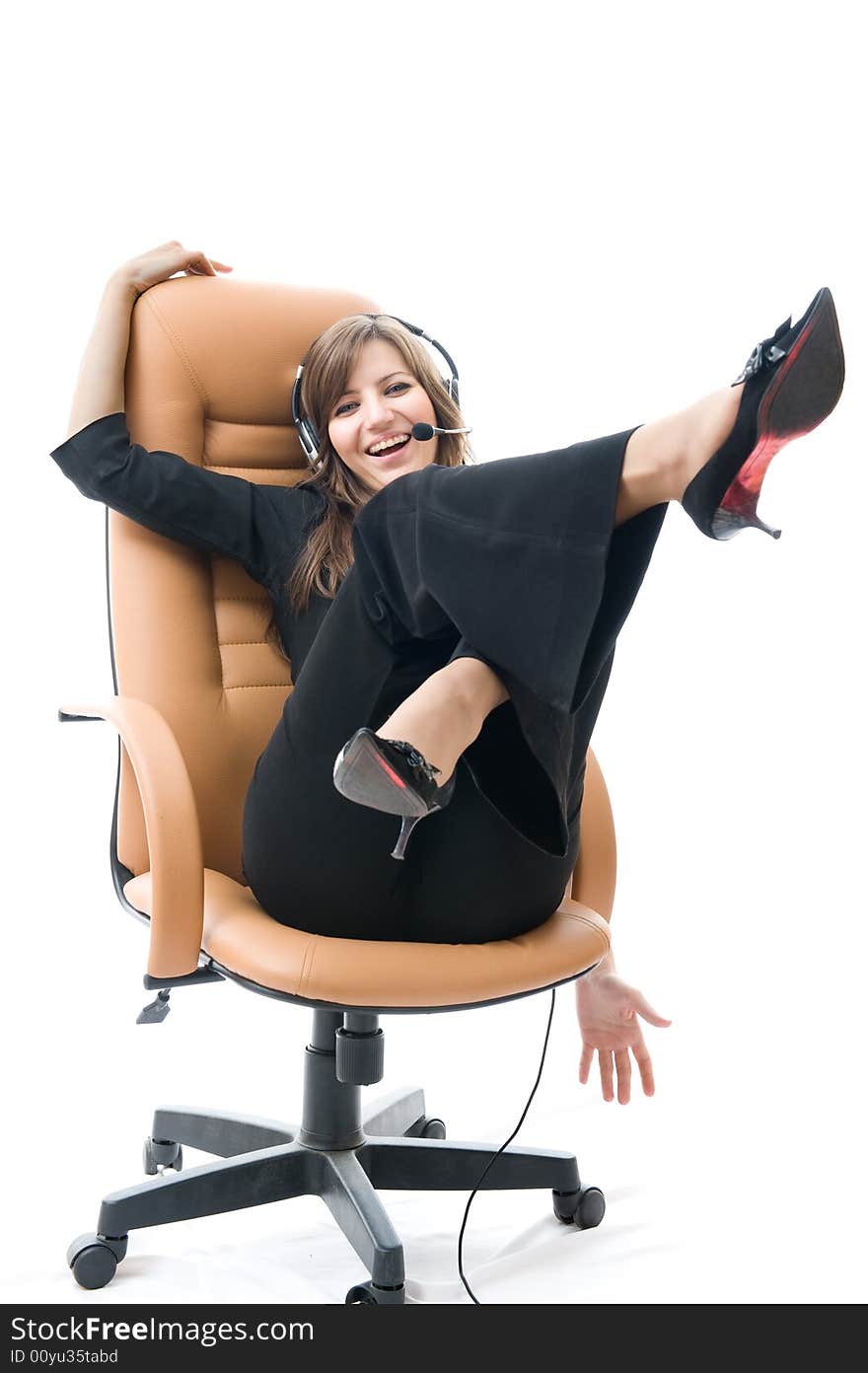 Young business woman on armchair Speaks by phone.